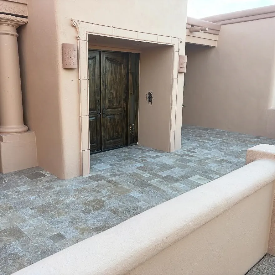 Gray stone pavers leading to a front door.