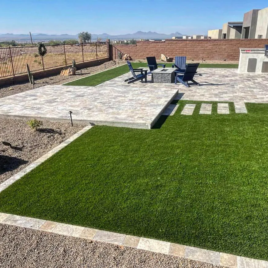 Artificial turf next to a paver patio